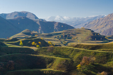 Mountain landscape with green agricultural terraces on the slopes in the Caucasus mountains.