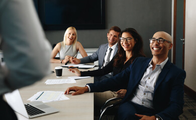 Collaborating for success, business people listen to a presentation in a meeting