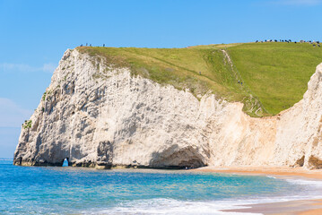 White chalk cliffs of Bat's Head and White Nothe seen from the beach near Durdle Door.