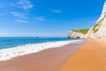 White chalk cliffs of Bat's Head and White Nothe seen from the beach near Durdle Door.
