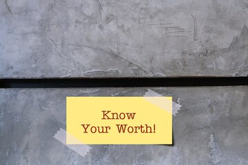 Note on copy space wall with text written KNOW YOUR WORTH, concept of internal measure of self...