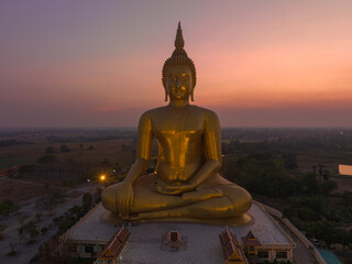 aerial view beautiful sky in twilight at the Biggest Buddha in the world at wat Maung Angtong Thailand.
scenery sky in twilight background.the one famous landmarks in Thailand.