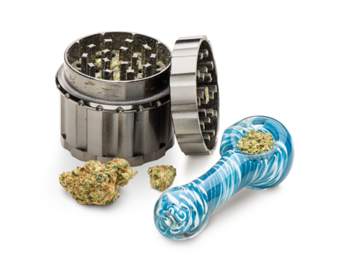 Glass pipe and cannabis grinder. Isolated on white background