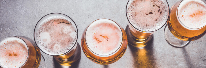 Beer glasses on gray stone background