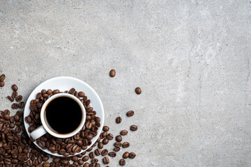 Cup of coffee with coffee beans on gray stone background. Top view - 585692728
