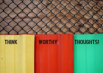 Colors wall with handwritten text inscription Think Worthy Thoughts!, means learning to control...
