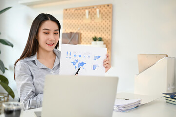 Charming Asian businesswoman having an online meeting with her marketing team