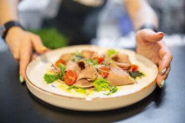 Chef cooking Beef tongue salad with fresh vegetables on restaurant kitchen