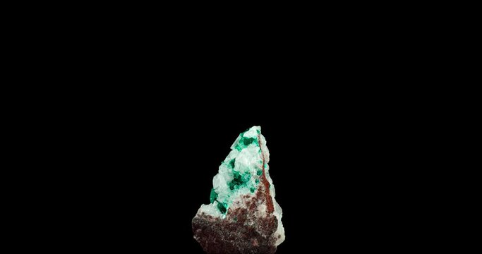 Dioptase crystal on white calcite. macro detail texture background. close-up raw rough unpolished semi-precious gemstone