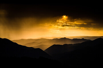 banner of mountain peaks in beautiful stormy sunset light