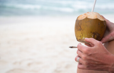 woman smoking a joint on the beach