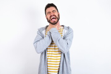 Young caucasian mán wearing trendy clothes over white background shouting suffocate because painful strangle. Health problem. Asphyxiate and suicide concept.