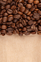 roasted whole arabica coffee beans, scattered on paper, isolated