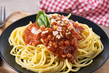 Spaghetti with bolognese sauce on wooden table. Close up