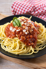 Spaghetti with bolognese sauce on wooden table