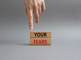 Your fears symbol. Wooden blocks with words Your fears. Beautiful grey background. Businessman hand. Business and Your fears concept. Copy space.