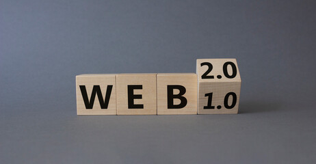 WEB 2 or 1 symbol. Turned wooden cubes with words WEB 1.0 or WEB 2.0. Beautiful grey background. Business and WEB concept. Copy space