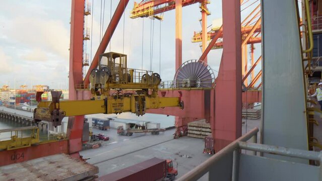 Ship crane loaded with container moving from a ship to load a truck in Colombia, buenaventura port