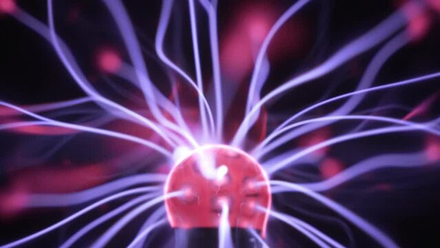 Plasma globe in slow motion. Blue and purple light beams and energy rays slowly moving inside the ball. Electric discharge. Tesla coil. Close up.