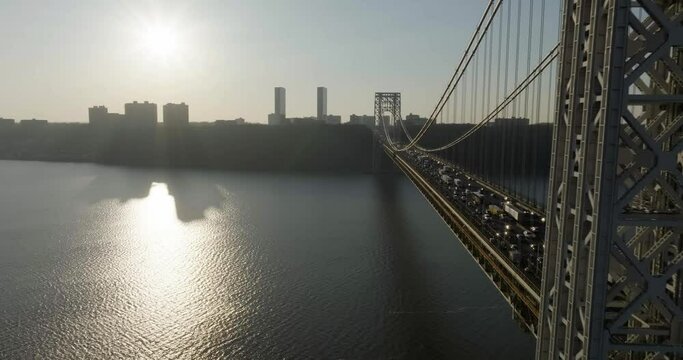 Traffic on George Washington bridge, evening sunburst in NY, USA - aerial view