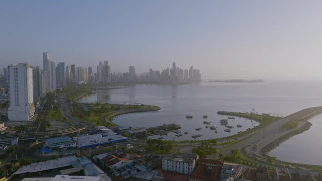 Drone wide shot of cinta costera, fish market mercado de marisco and the skyline in the back while moving forward