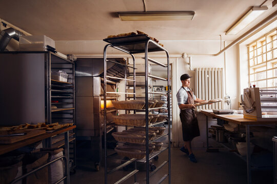 Baker preparing dough in kitchen