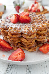 Waffle stack with strawberries. Fresh and homemade baked for mothers day