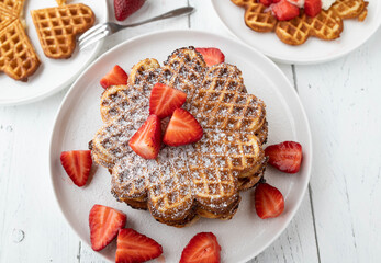 Waffle stack with fresh strawberries on white background from above