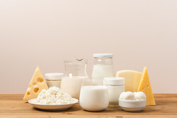 Variation of organic dairy products on wooden table. Farm cheeses, milk, cottage cheese, yogurts on...