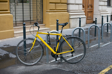 Fototapeta na wymiar A bicycle parked on the street. Bike parking. Eco green city. Bike theft problem. minimizing carbon footprint.