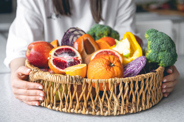 Big basket with fruits and vegetables, close-up.