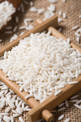 Organic raw sticky rice or glutinous rice  on table