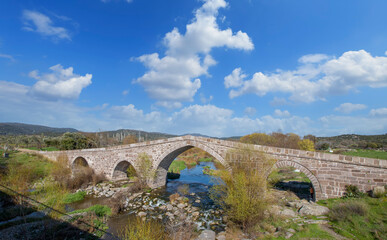 Fototapeta na wymiar Ruins of the ancient bridge (Murat Hüdavendigar Bridge) in Assos, Turkey.