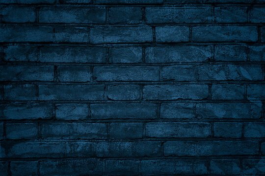 Navy blue brick wall texture. Indigo color brickwork. Dark grunge background