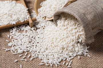 Organic raw sticky rice or glutinous rice  on table