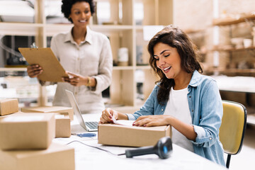 Creative female entrepreneur preparing an online order for shipping