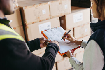 Logistics manager signing a bill of lading in a warehouse