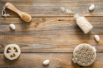 Spa composition with body care items on wooden background, top view.