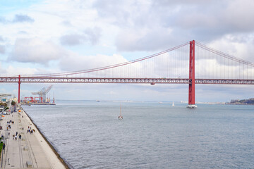 Beautiful landscape with suspension 25 April bridge bridge over the Tagus river in Lisbon, Portugal.