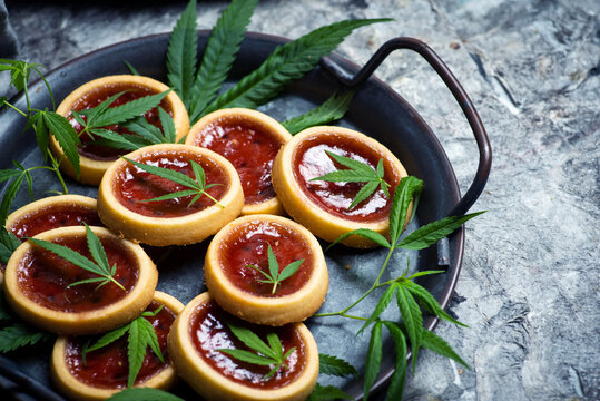 Biscuit with strawberry jam and marijuana leaf