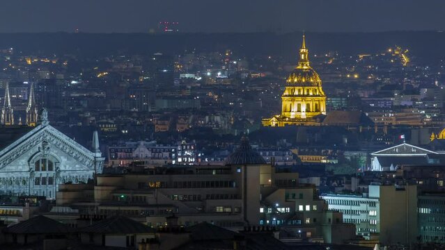 Paris night cityscape timelapse seen from Montmartre with Garnier opera and Les Invalides golden dome. Top aerial view from viewpoint. Paris, France