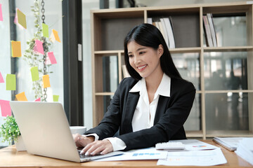 Fototapeta premium Young pretty business woman with notebook in the office