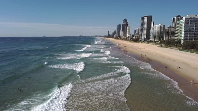 an ascending aerial clip facing south on main beach at surfers paradise on the gold coast of qld, australia