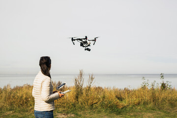 Woman flying drone using remote control