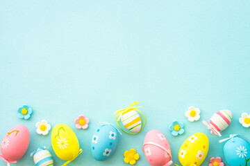 Easter eggs and spring decor on blue background. Flat lay with copy space.