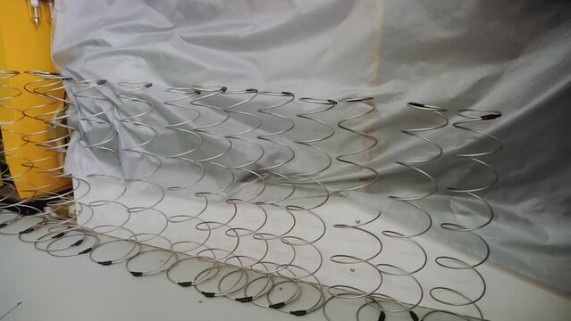Row of metal springs on floor in parachute making workshop