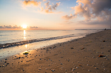 Fototapeta na wymiar Sunset on the beach with clouds