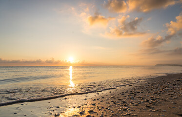 Obraz premium Sunset on the beach with clouds