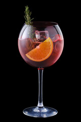 Cold sangria with orange and rosemary in a wine glass