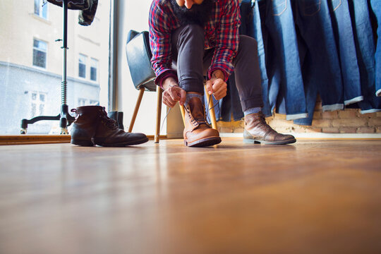 Man trying on shoes in store
